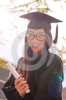 Portrait, woman and happy for college graduation on campus with celebration, success and completion for qualification