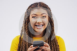 Portrait, woman and happy with phone in studio for, social media, networking and blog. Gen z, female person and