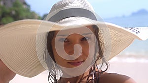 Portrait woman in hat taking a selfie on a beautiful exotic beach in Thailand. 3840x2160