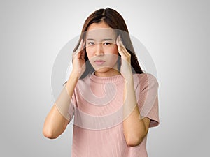 Portrait of woman have a headache  on gray background