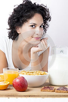Portrait of woman having breakfast at morning on bed on white ba
