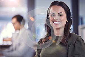 Portrait, woman and headset with microphone in callcenter or customer care with smile and positivity. Female person