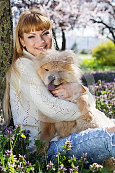 Portrait of a woman with her dog outdoors