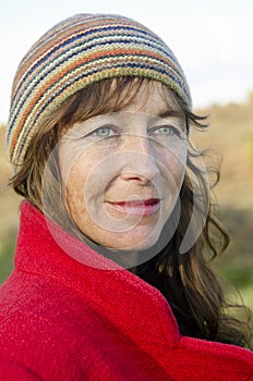 A portrait of a woman in her forties wearing a red