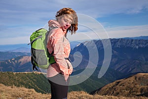 Portrait of a woman with her hair in the wind, in Iezer-Papusa mountains, part of the Carpathian mountains. Copy space