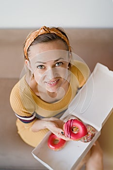 Portrait woman holding box donuts