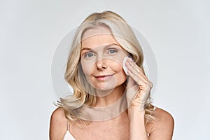 Portrait of woman holding cotton pad doing everyday routine makeup removing.