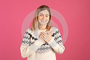 Portrait of woman holding hands near heart