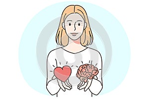 Woman holding heart and brain