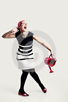 Portrait of woman holding a red watercan
