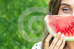 Portrait of woman holding slice of watermelon