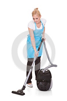 Portrait of woman holding vacuum cleaner