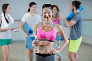 Portrait of woman holding water bottle