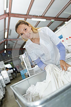 Portrait woman in industrial laundrette