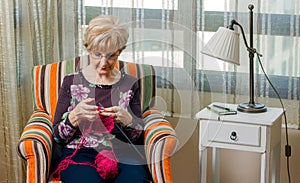 Portrait of woman knitting a wool sweater