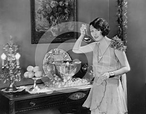 Portrait of woman with ladle and punch bowl
