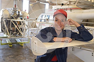 Portrait woman leaning on wing aircraft