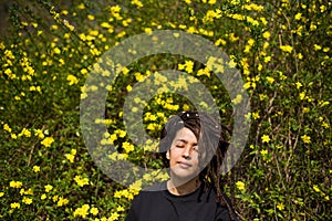 Portrait of woman with locs shot against flower background