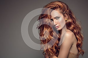 Portrait of woman with long curly beautiful ginger hair.