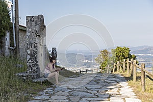 Portrait of woman looking at the cellphone on her vacations in Galicia, viacrucis del Monte de Santa Tecla