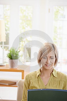 Portrait of woman looking at laptop
