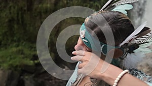 Portrait of woman looks like indian shaman in forest