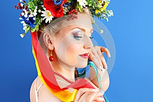 Portrait woman makeup with flowers on blue background