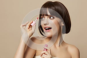 portrait woman makeup lipstick in hand model posing beige background