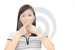 Woman making silence gesture