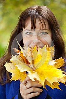 Portrait of woman with maple posy