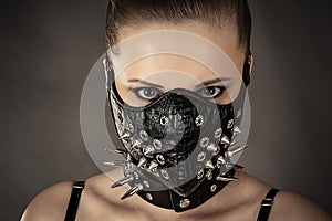 Portrait of a woman in a mask with spikes