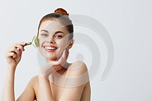 portrait woman massage roller anti aging facial treatment close-up Lifestyle