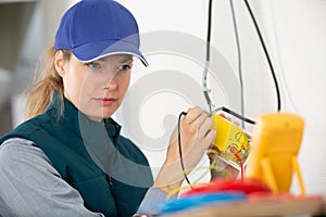 Portrait woman measuring electrical current