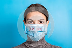 Portrait of a woman in medical mask with SARS virus text at blue background. concept. Respiratory protection