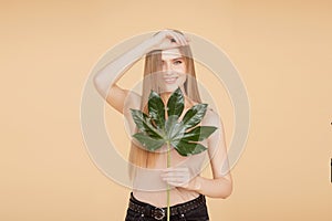 Portrait woman with natural green leaf, blond model girl with clear skin face. Concept Fashion flora beauty