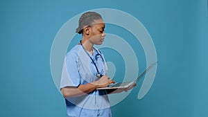 Portrait of woman nurse working on modern laptop