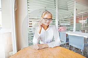 Portrait of woman in office with earphone