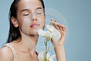 portrait woman orchid near face cosmetics clean skin tenderness isolated background