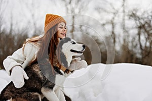 portrait of a woman outdoors in a field in winter walking with a dog fresh air