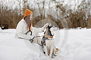 portrait of a woman outdoors in a field in winter walking with a dog Lifestyle