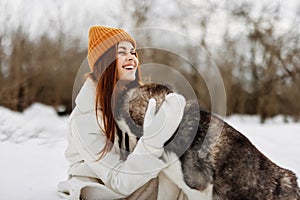 portrait of a woman outdoors in a field in winter walking with a dog winter holidays
