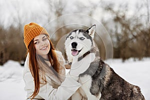 portrait of a woman outdoors in a field in winter walking with a dog winter holidays