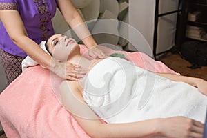 Portrait of woman patient in ayurveda spa wellness center lying relaxed