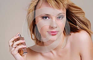 Portrait of woman with perfume bottle