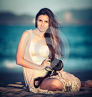Portrait of a woman photographer with camera