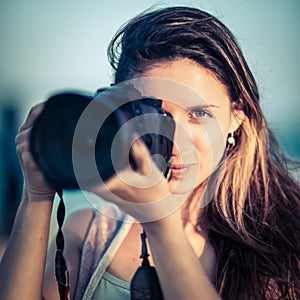 Portrait of a woman photographer with camera