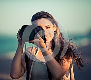 Portrait of a woman photographer with camera