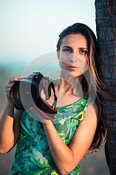 Portrait of a woman photographer with camera