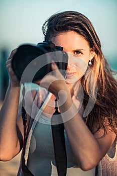 Portrait of a woman photographer with camera