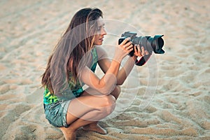 Portrait of a woman photographer with camera